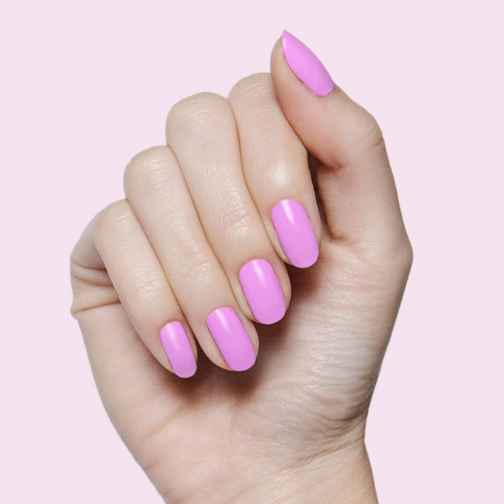 Hand with nails painted in Fierce & Loving lilac gel polish for a smooth, long-lasting manicure by Olive and June