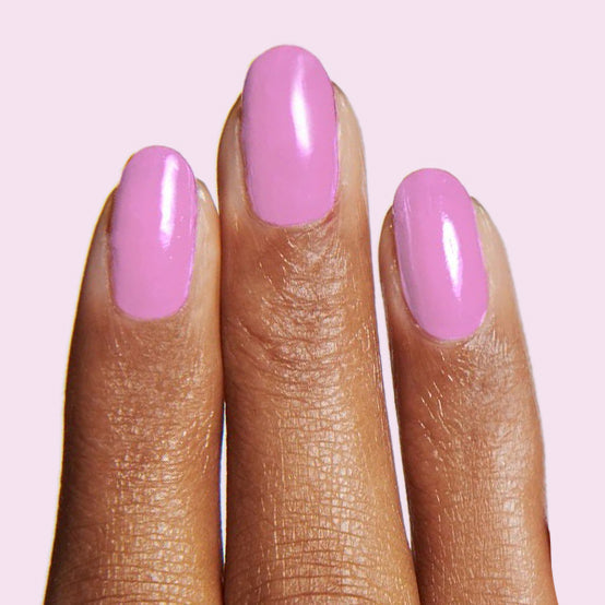 Fingers with nails painted in Fierce & Loving lilac gel polish for a smooth, long-lasting manicure by Olive and June