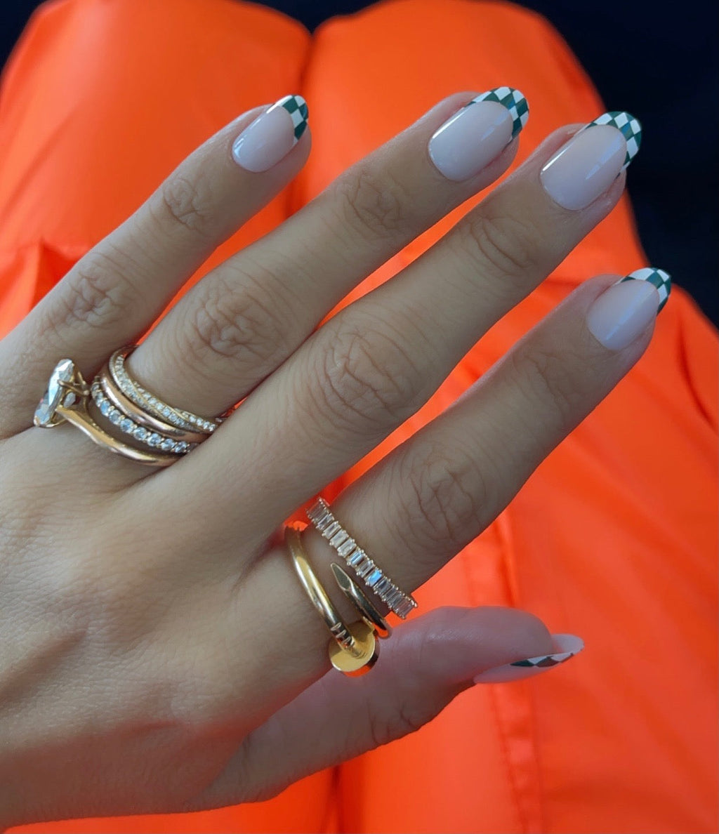 Checkerboard French - Press-On | Short | Round hand with short round false nails featuring green and white checkered tips on neutral base
