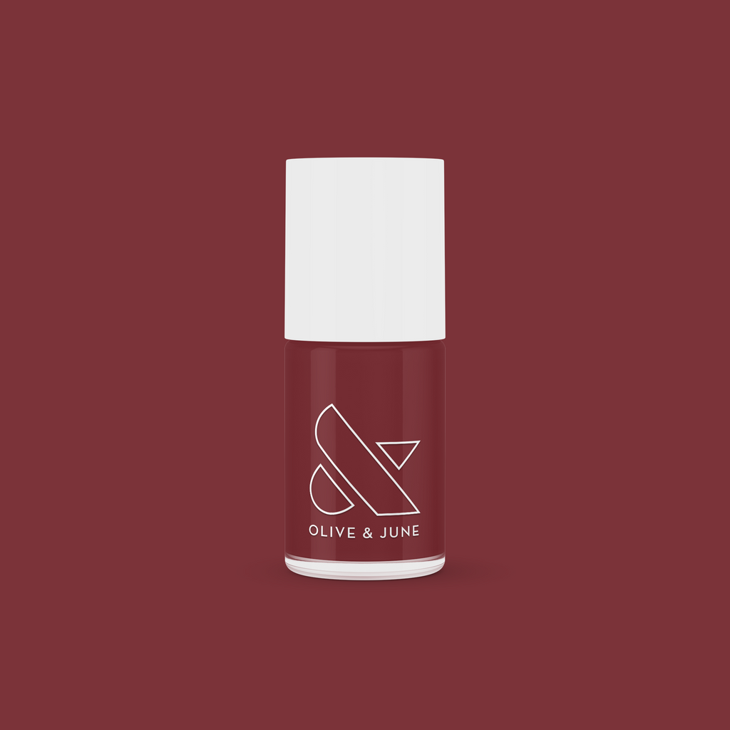 Bottle of JJ nail polish by Olive and June in a rich cinnamon brown shade for at-home manicures and pedis