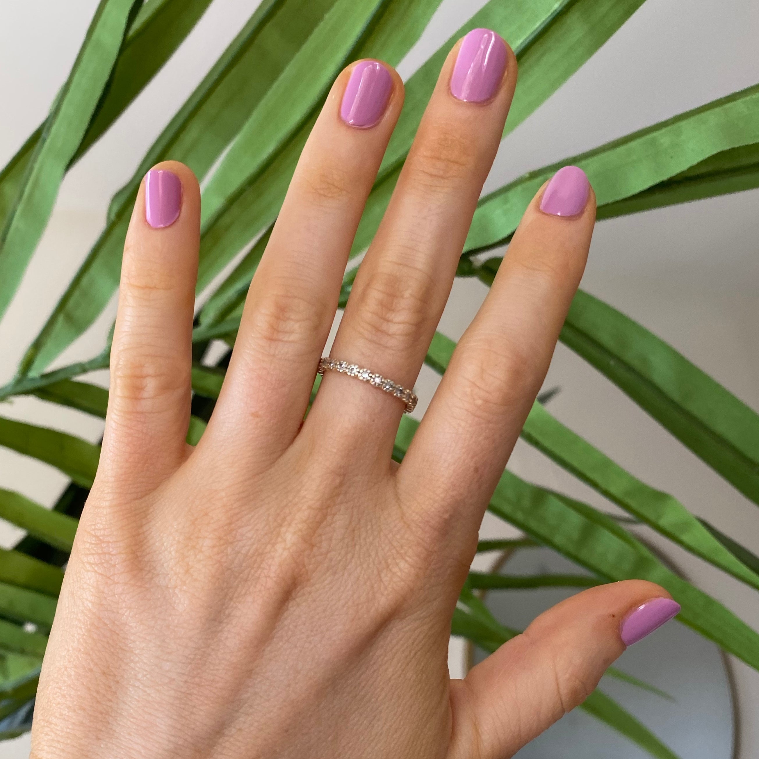 Hand with nails painted in Fierce & Loving lilac gel polish showcasing a smooth, long-lasting manicure by Olive and June