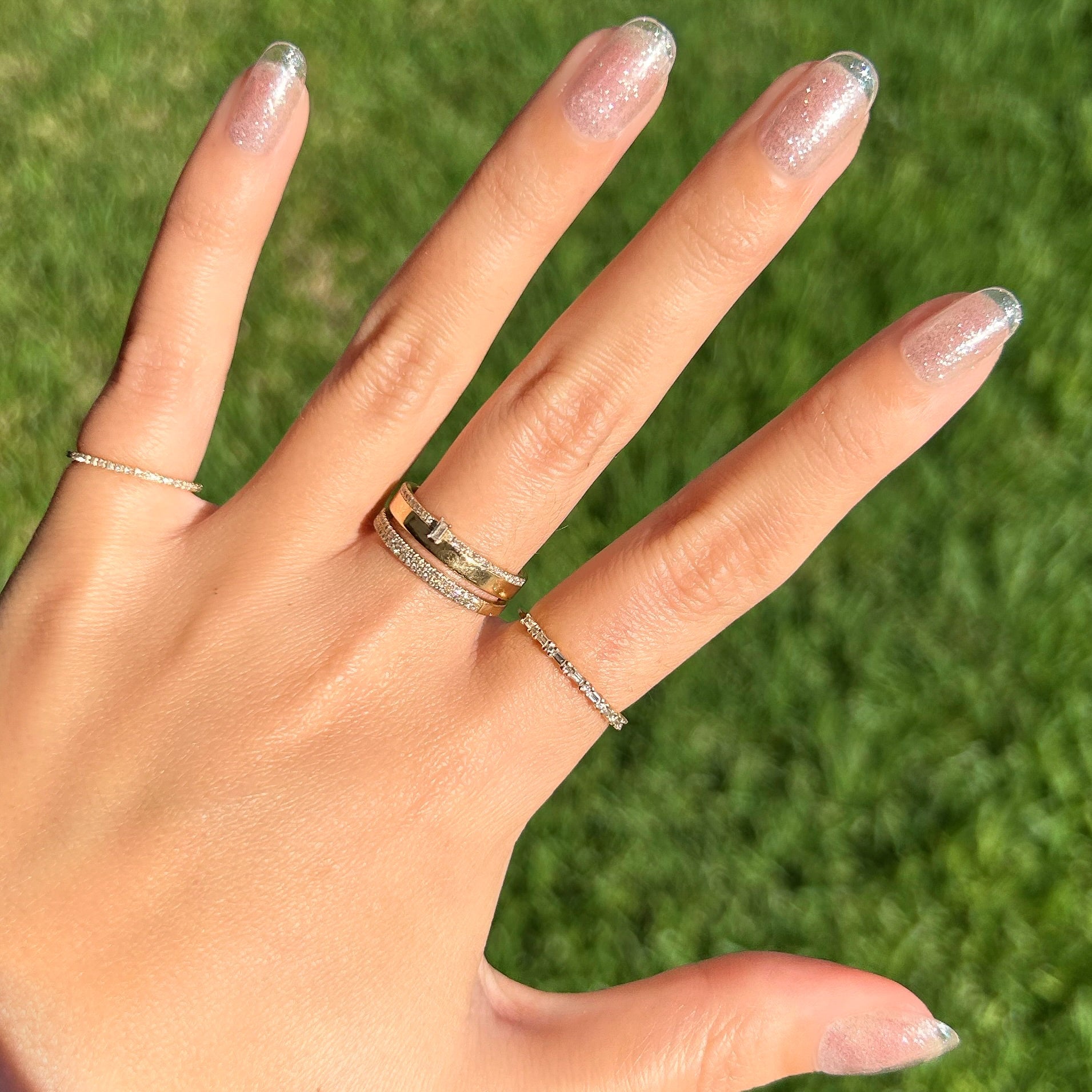 Pure Glitter - Press-On | Short | Round showing short round false nails with subtle silver glitter in clear base outdoors manicure