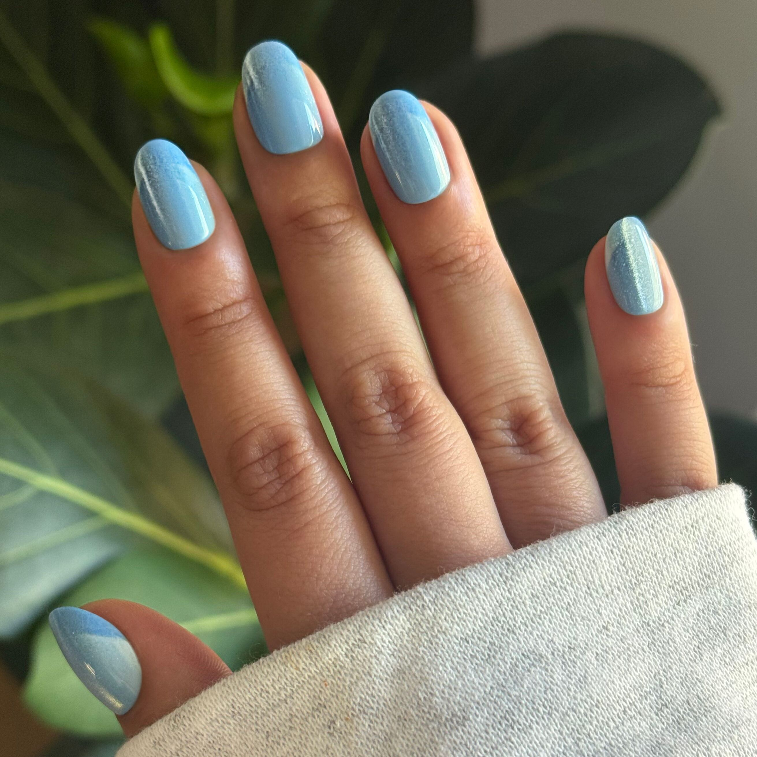 Axolotl Velvet Illusion French - Press-On | Short | Round showing hand with light blue velvet-inspired nails and subtle French tips