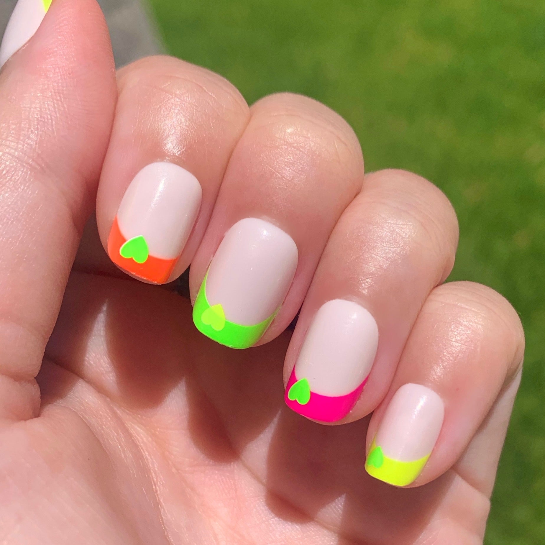Neon Heart French | Squoval | Extra Short press-on nails with neutral base and multicolor neon tips featuring small heart accents