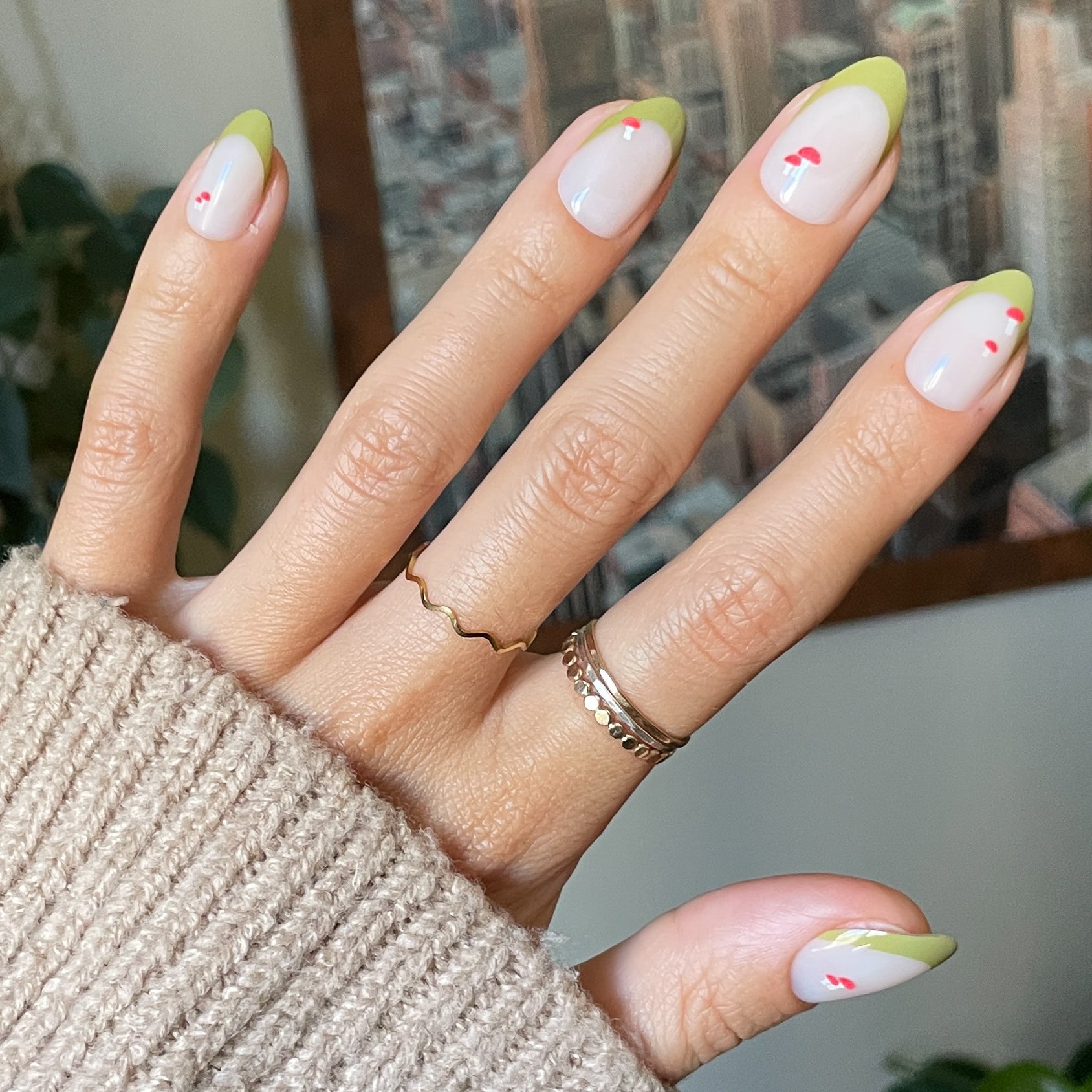 Mushroom Fall French - Press-On | Medium | Almond nails with green tips and small red mushroom details on hand with rings