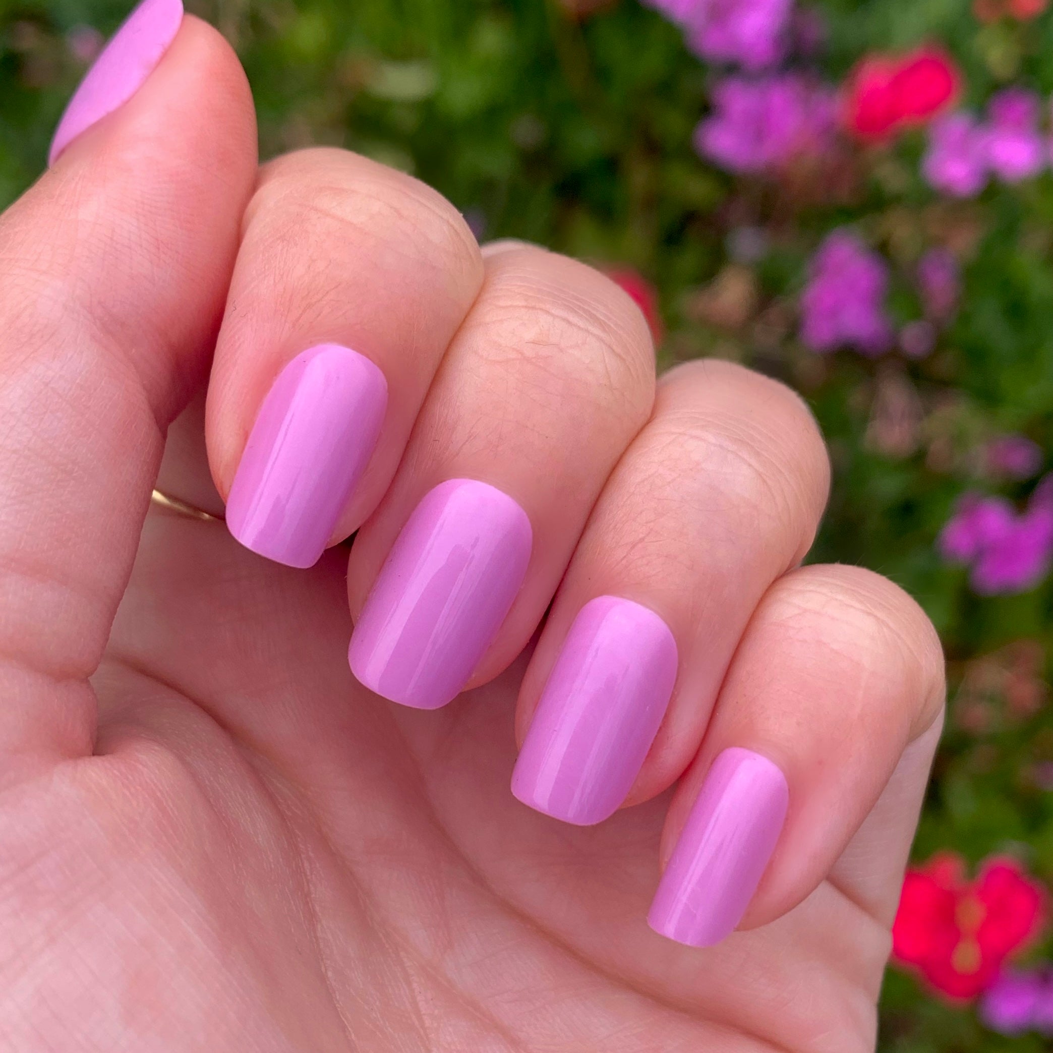 Hand with Fierce & Loving | Squoval | Short showing glossy lilac short squoval press-on nails outdoors