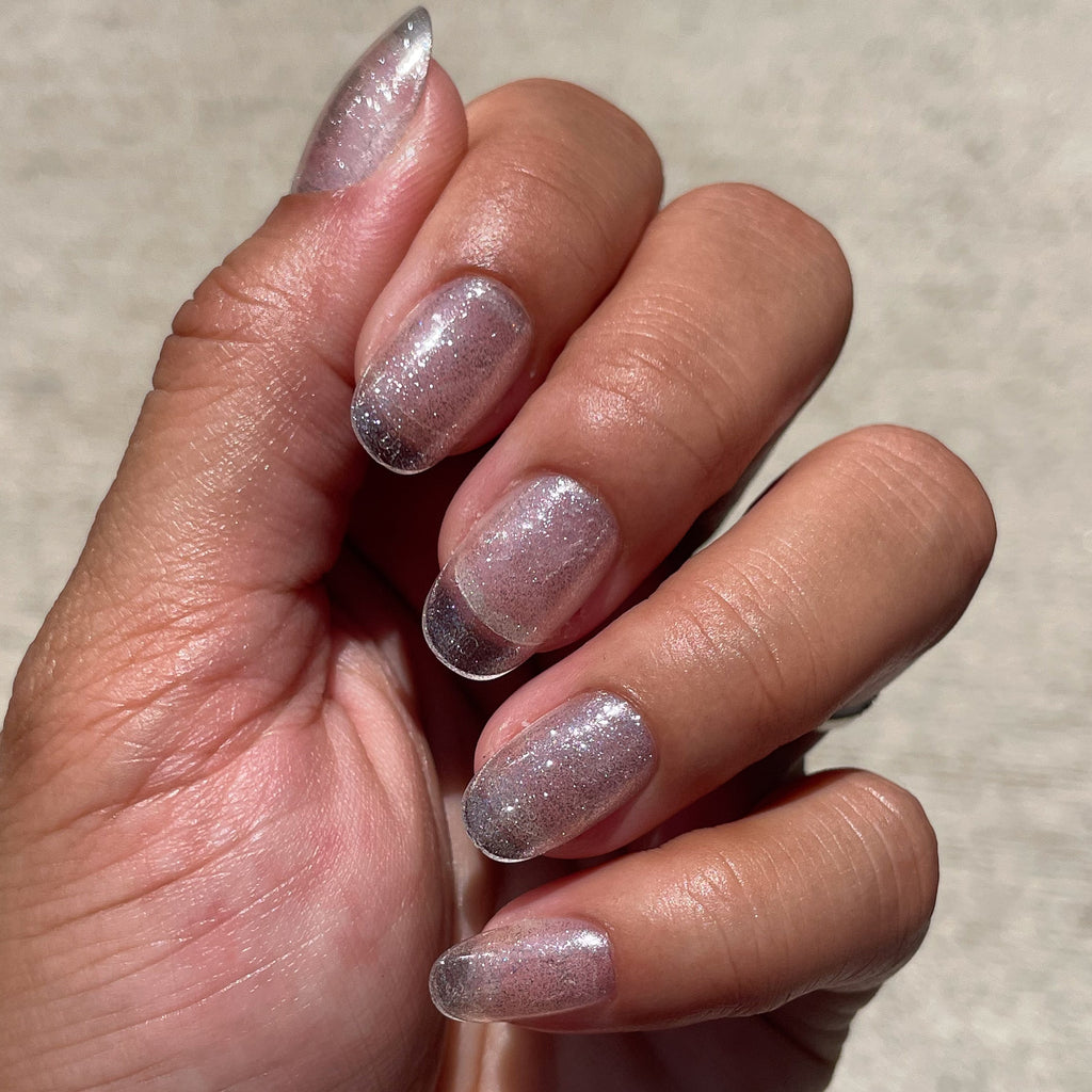 Pure Glitter - Press-On | Short | Round showing short round false nails with silver glitter polish for an easy at-home mani
