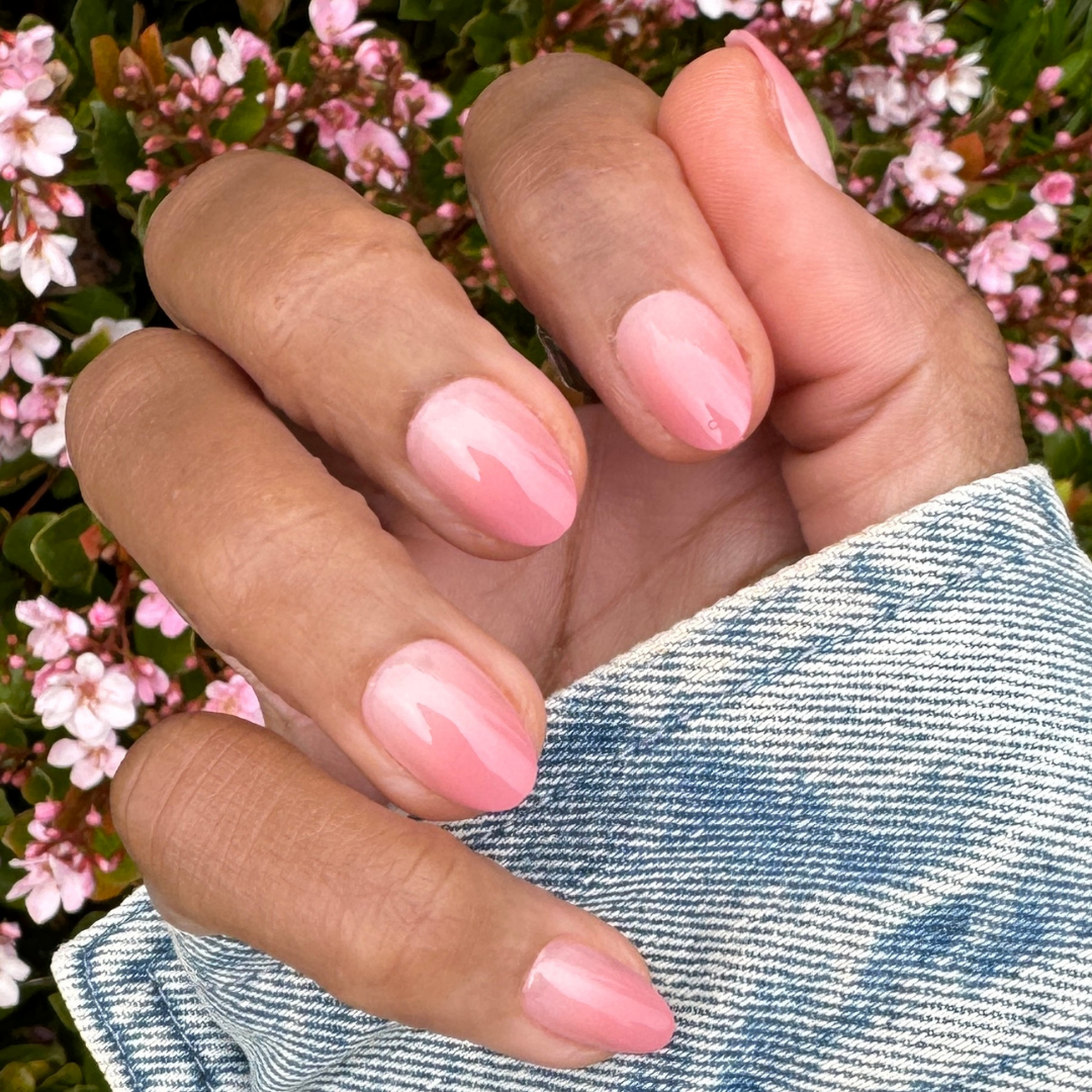 Blush Syrup Gradient - Press-On | Short | Almond showing hand with short almond warm blush gradient press-on manicure outdoors