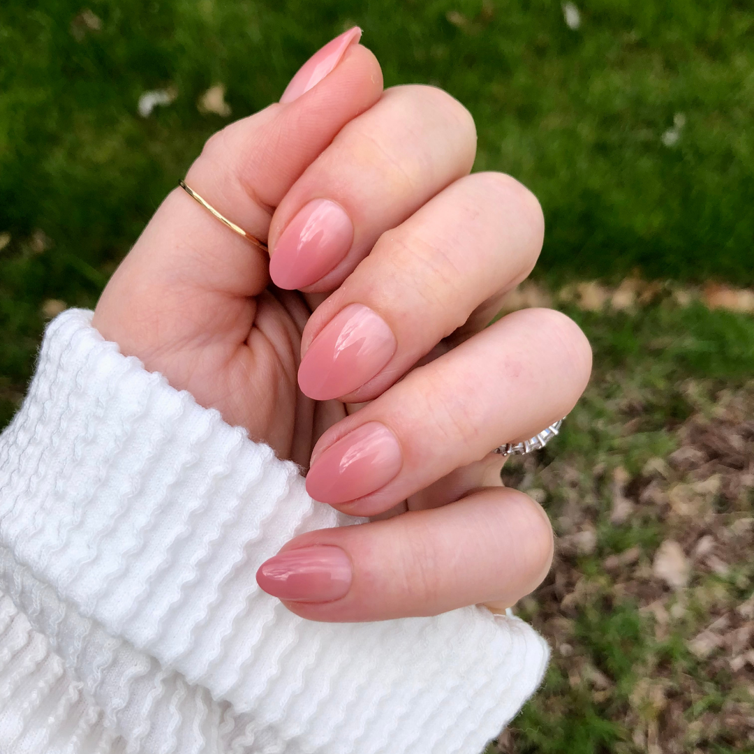 Blush Syrup Gradient - Press-On | Short | Almond featuring hand with short almond-shaped warm rose blush gradient press-on manicure outdoors