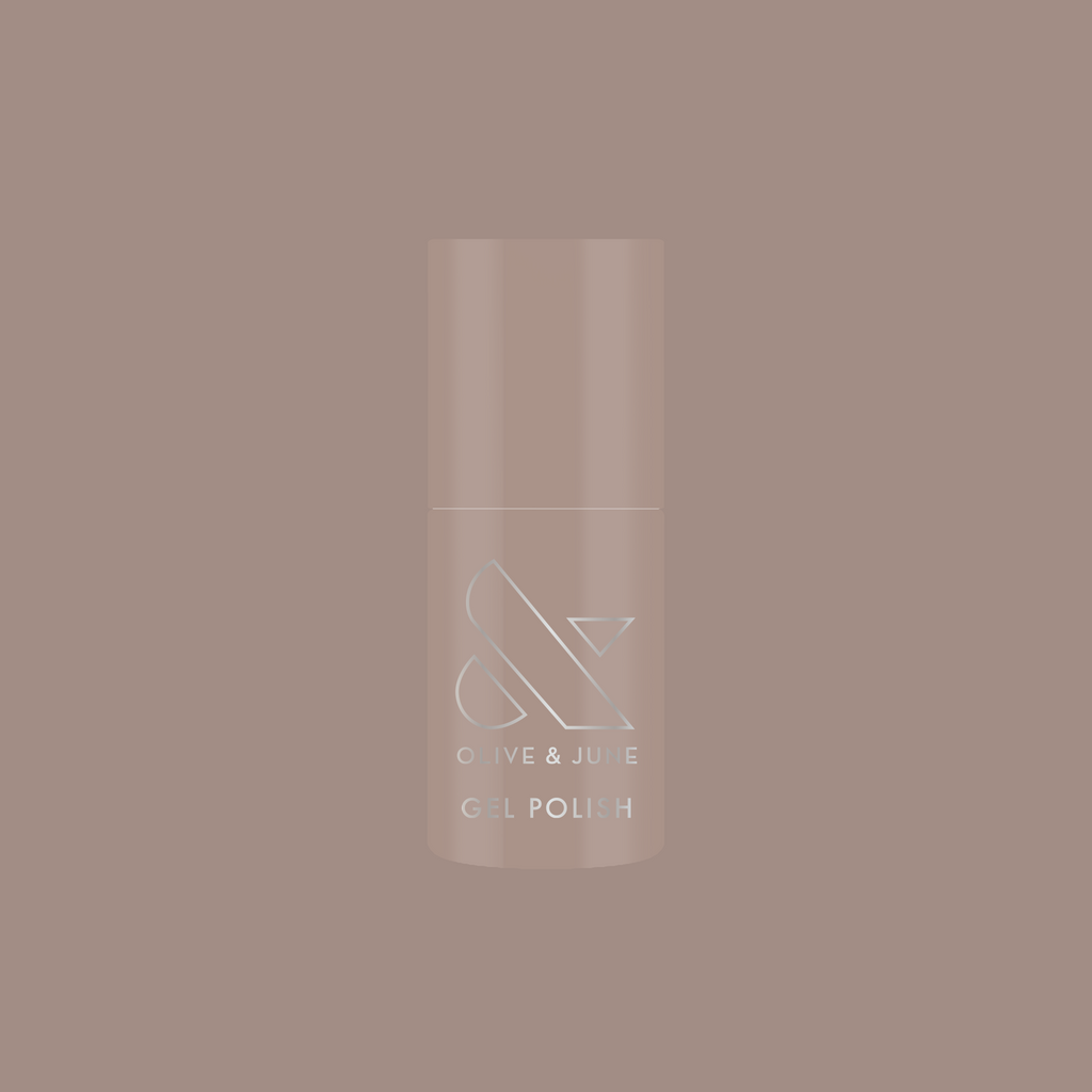 Bottle of AW - Gel polish in warm grey shade for chic, long-lasting manicure by Olive and June on muted background