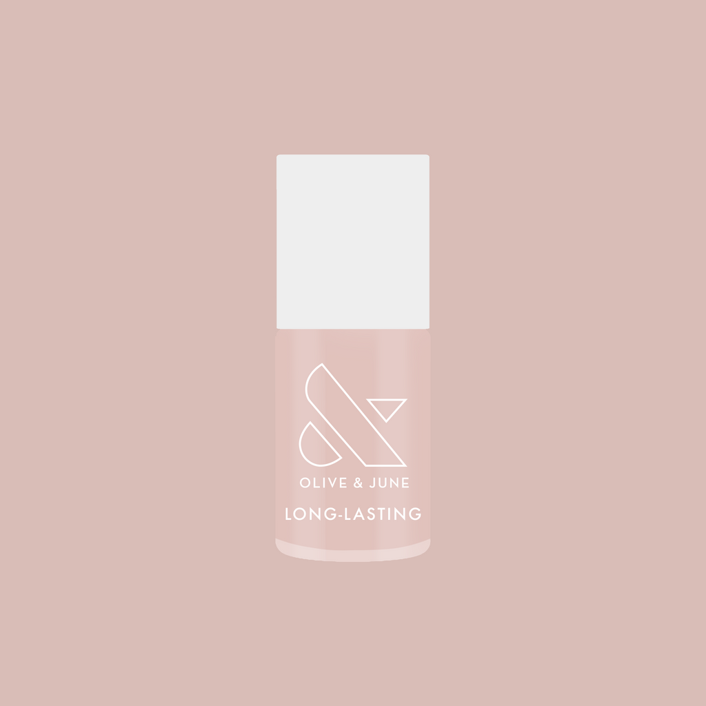 Bottle of Dream Job long-lasting nail polish in a soft milky sheer pink shade on a matching background