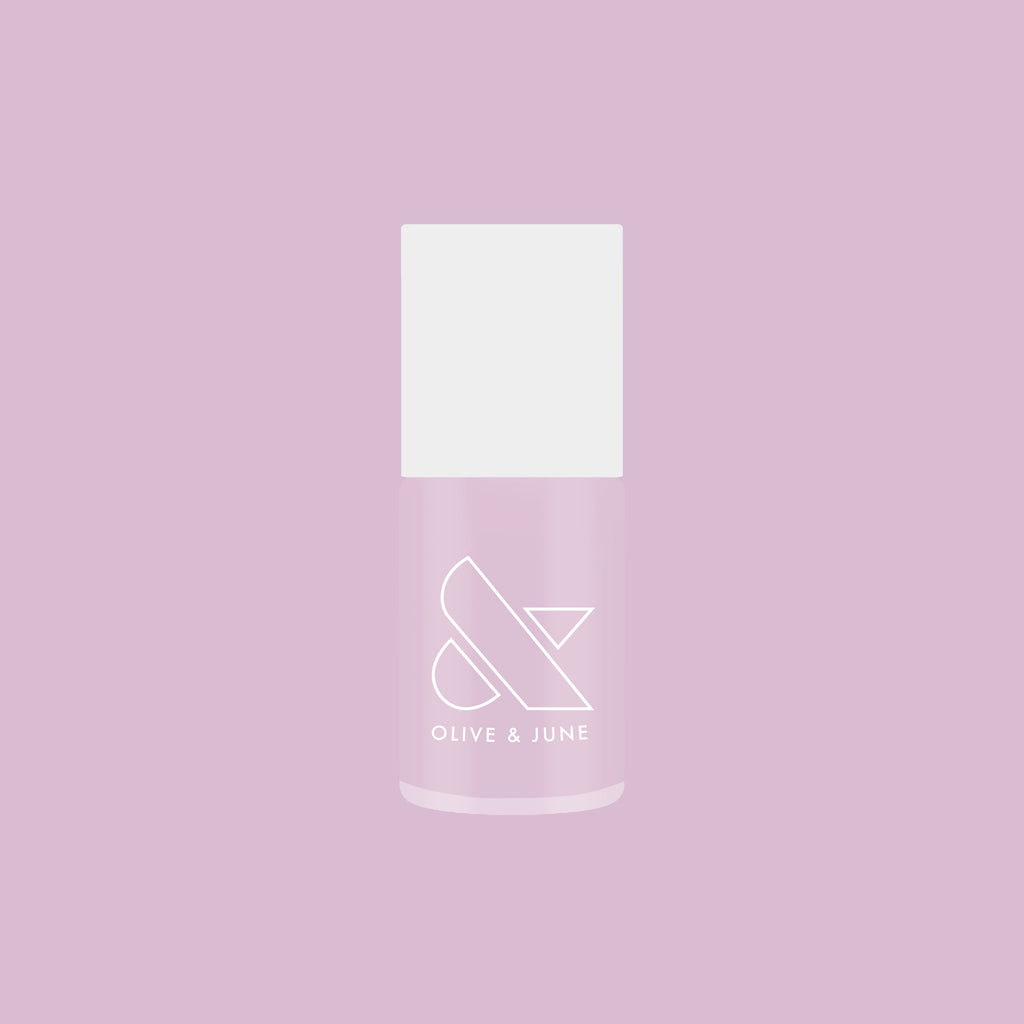 Bottle of Passionfruit Gloss quick dry gel polish in milky lavender shade on soft purple background