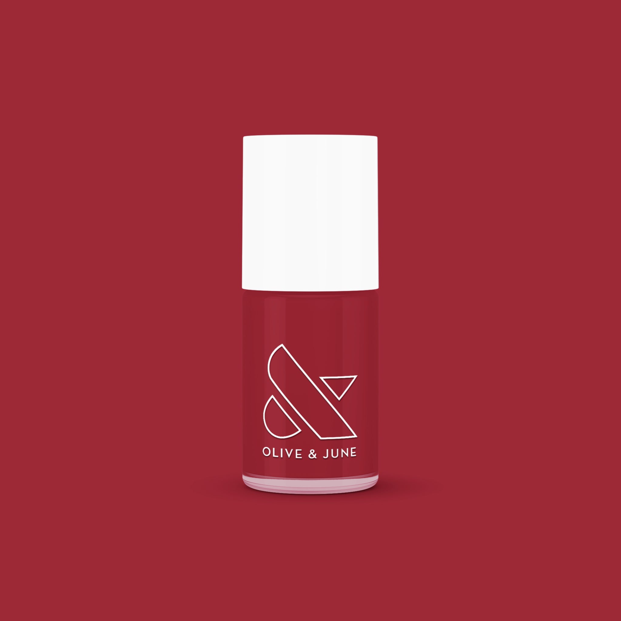 Bottle of Olive and June Cozy Up nail polish in warm brick red for mani and at-home manicure looks