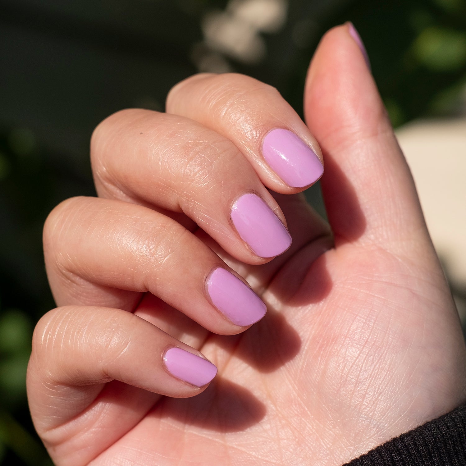 Hand showing nails painted in Fierce & Loving lilac gel polish for a vibrant, long-lasting manicure by Olive and June