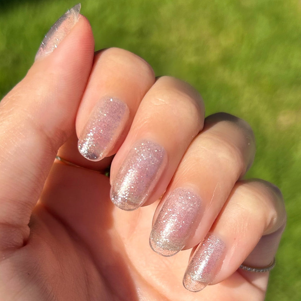 Pure Glitter - Press-On | Short | Round showing short round false nails with silver glitter polish for a sparkling at-home mani