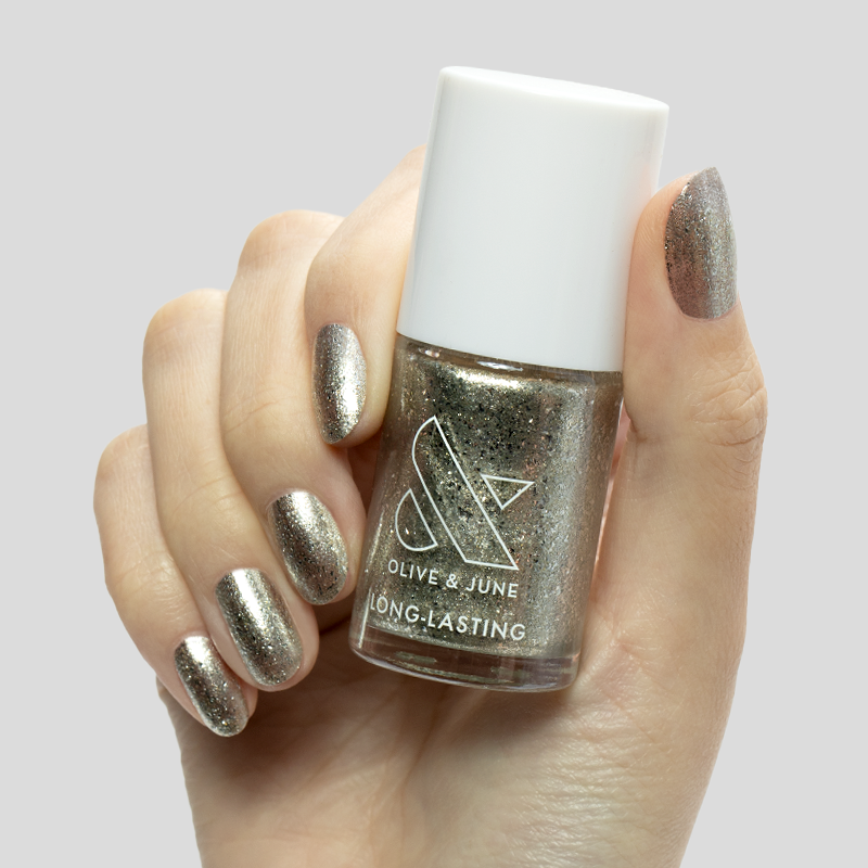 Candy Wrapper metallic silver polish on nails and bottle held for a dazzling long-lasting mani finish