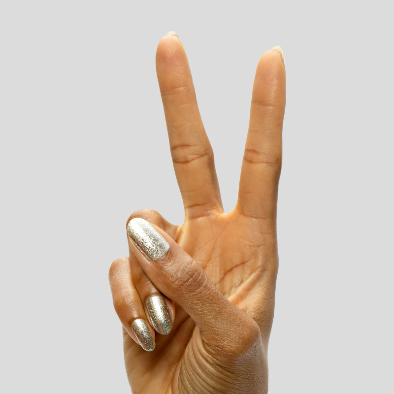 Candy Wrapper silver metallic polish on nails held in a peace sign showcasing a shiny long-lasting manicure finish
