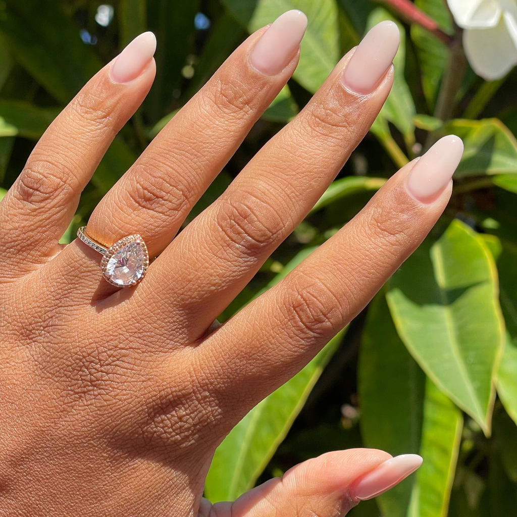 Cashmere Kiss - Builder Gel on natural almond-shaped nails with soft sheer greige manicure in outdoor natural light