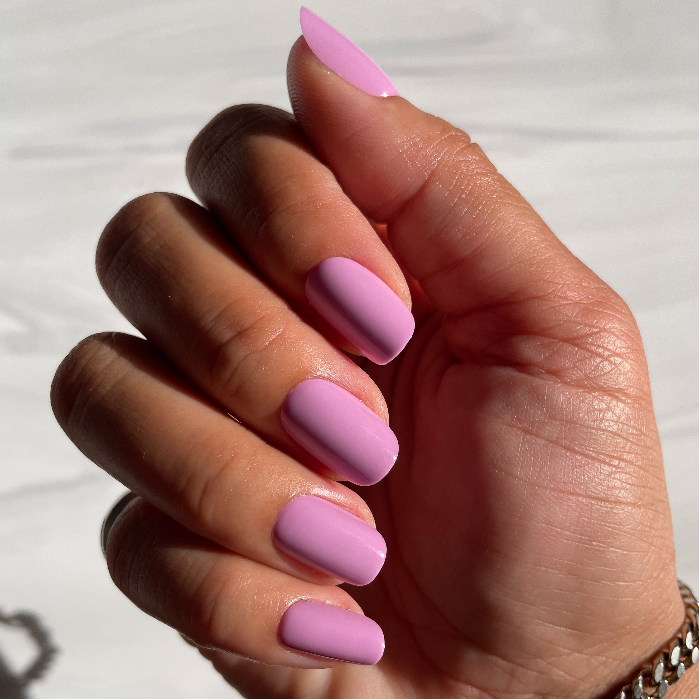 Hand with Fierce & Loving | Squoval | Short lilac short squoval press-on nails in natural sunlight showing smooth finish