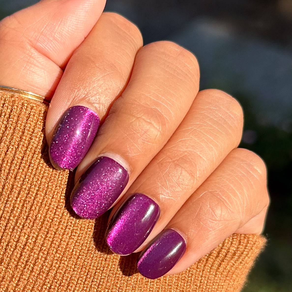 Velvet Plaza - Press-On | Extra Short | Round deep mulberry chrome velvet finish false nails on natural hand outdoors