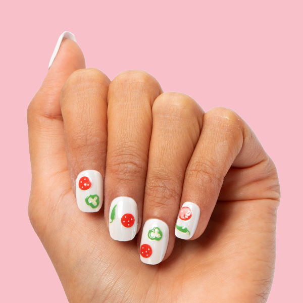 White Chrome - Press-On | Extra Short | Squoval off-white nails with pizza topping nail art displayed on hand against pink background