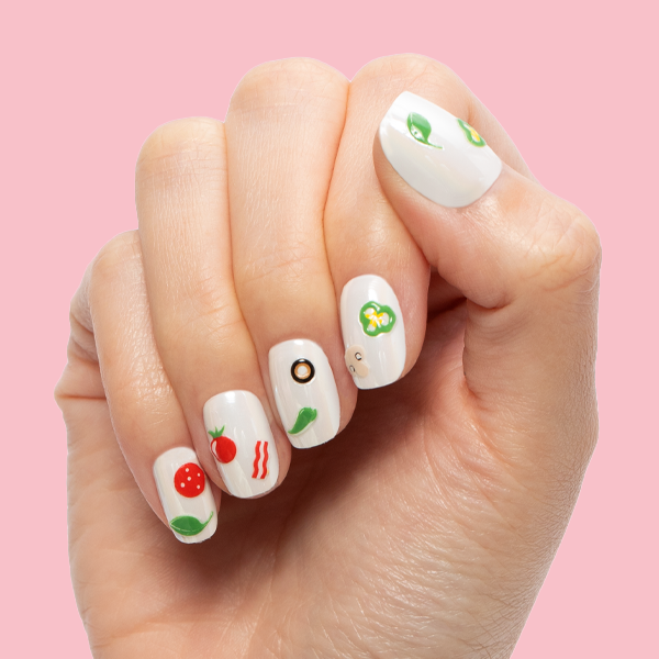 White Chrome - Press-On | Extra Short | Squoval off-white press-on nails with playful pizza topping nail art on hand against pink background