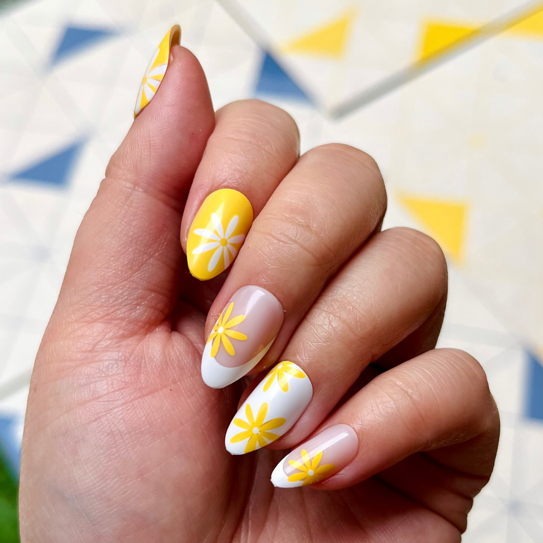 Floral Fun - Press-On | Medium | Almond showing hand with bright yellow and white floral french manicure press-on nails