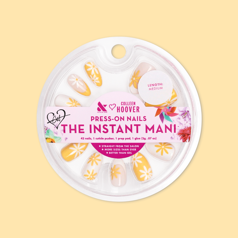 Floral Fun - Press-On | Medium | Almond showing medium almond false nails with marigold and white floral french design in packaging