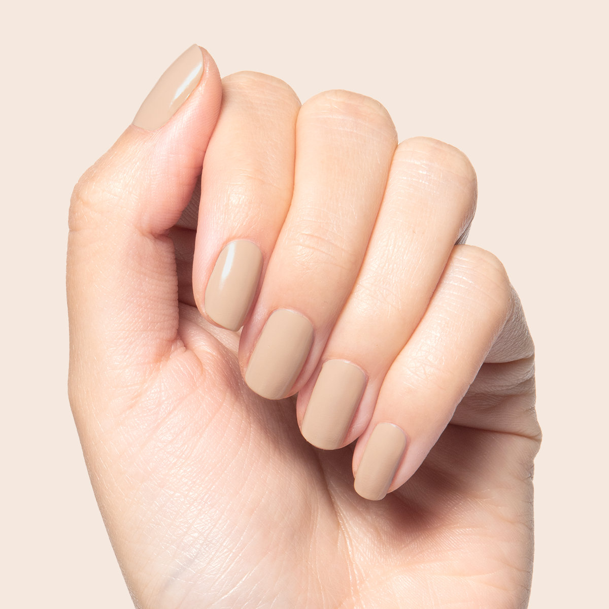 Real Toasty neutral beige nail polish shown on hand for a cozy, natural mani with long-lasting finish at home