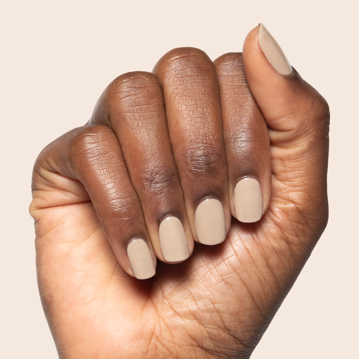 Real Toasty nail polish on hand showing neutral beige gel polish for a comfortable and long-lasting mani at home