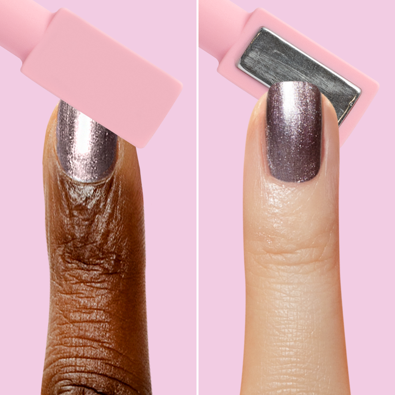 Two fingers with Lavender Velvet polish showing magnetic wand use for shimmering velvet nail manicures on pink background