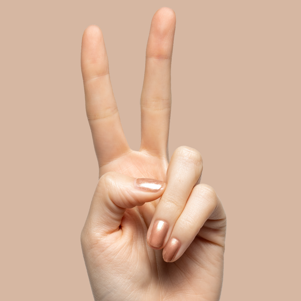 Hand showing peace sign with nails polished in Coconut Shimmer Gloss sheer warm chestnut polish with silver sparkle