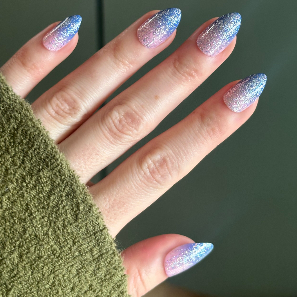 Hand with Major Glitter Gradient - Press On | Medium | Almond showing sparkly blue to pink gradient press-on mani in medium almond shape