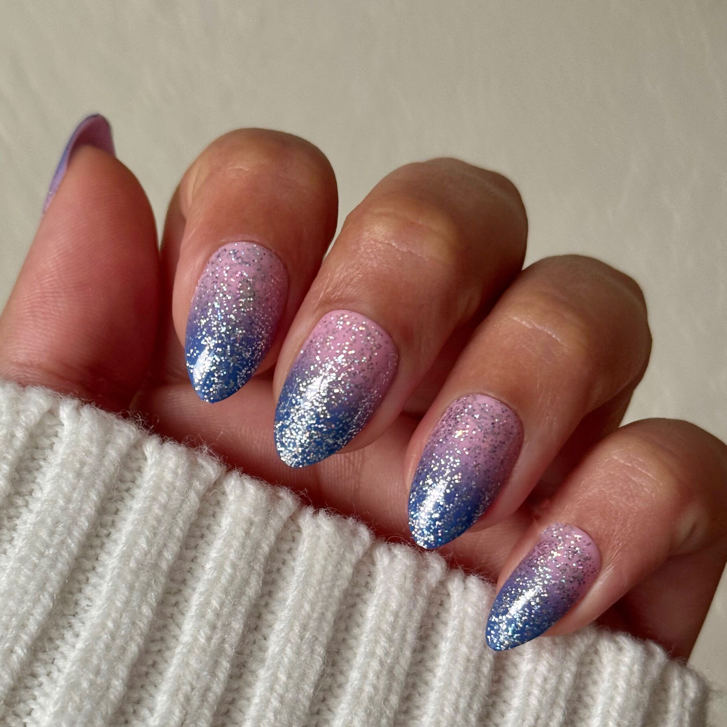 Hand wearing Major Glitter Gradient - Press On | Medium | Almond with sparkly pink to blue glitter gradient mani in almond shape