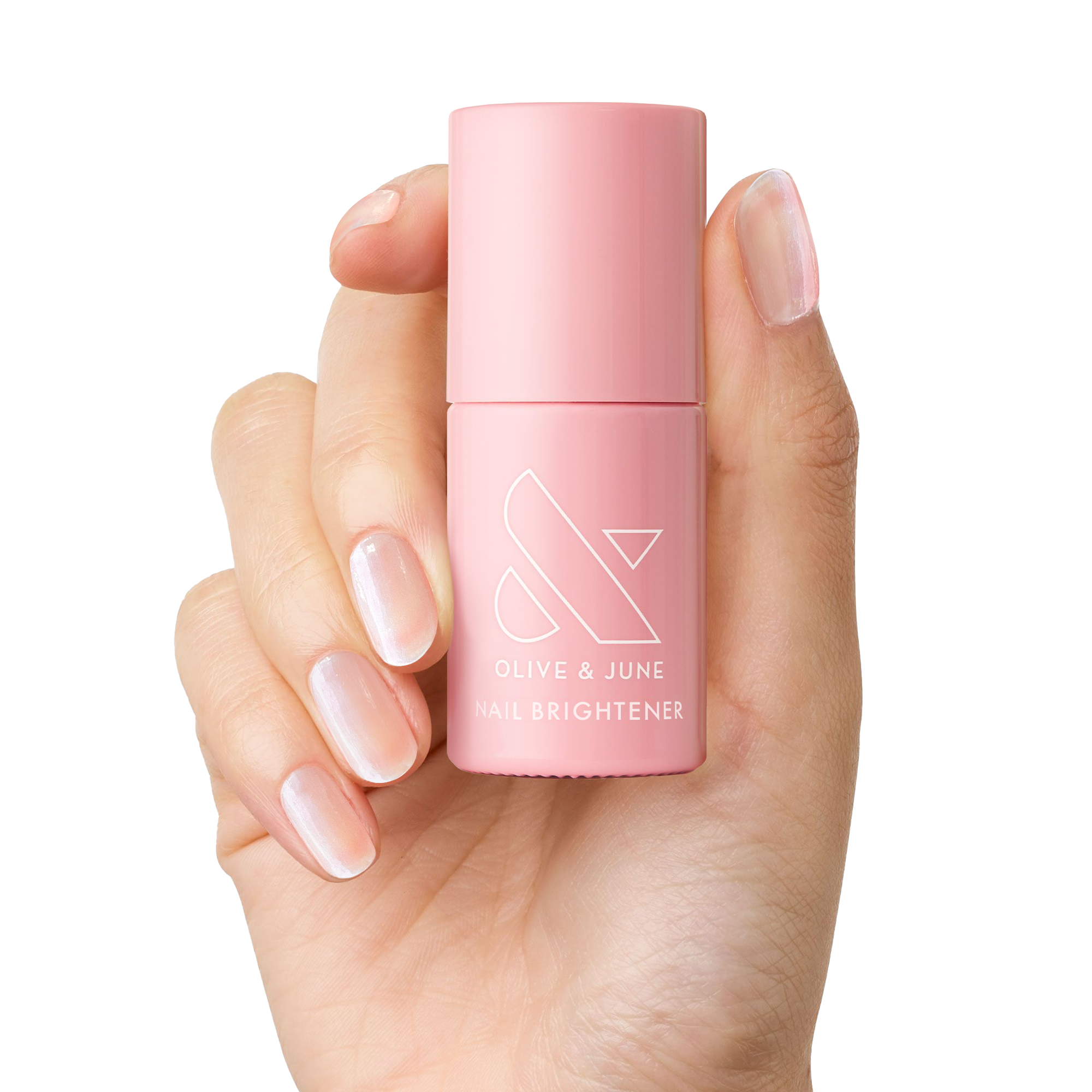 Hand holding pink bottle of The Nail Brightener by Olive and June for brightening stained nails and at-home mani care