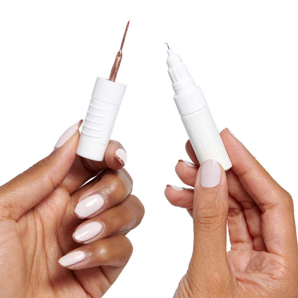 Nail Art Pen - HD in crisp white held open to show dual tips for precise at-home mani designs with long-lasting polish