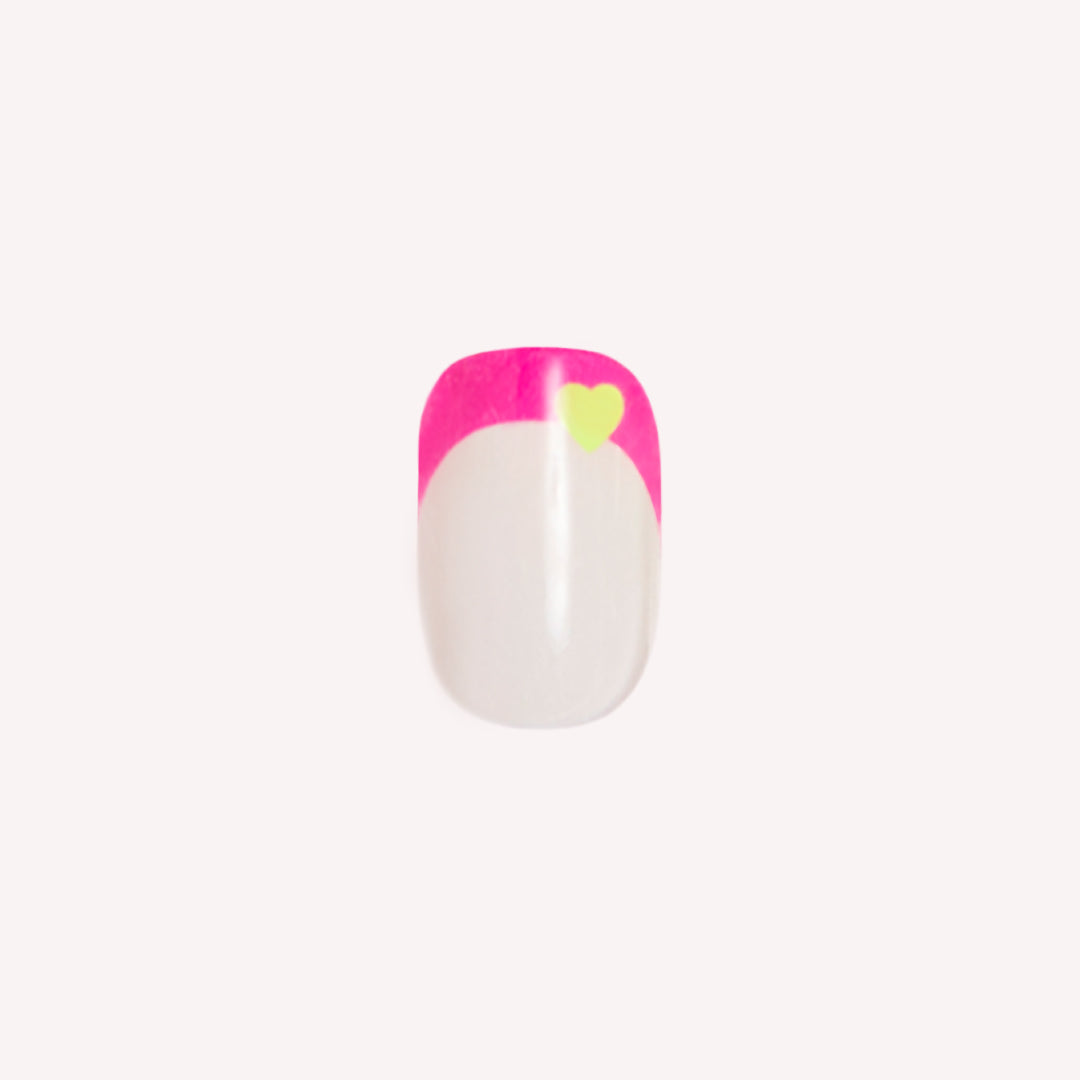 Neon Heart French | Squoval | Extra Short press-on nail with neutral base, neon pink tip, and small yellow heart detail