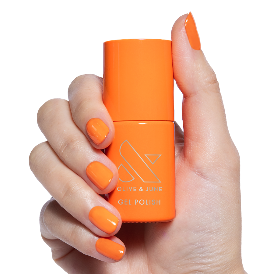 OOO 4EVA - Gel bright tangerine orange gel polish bottle held by hand with matching manicured nails for vibrant mani look