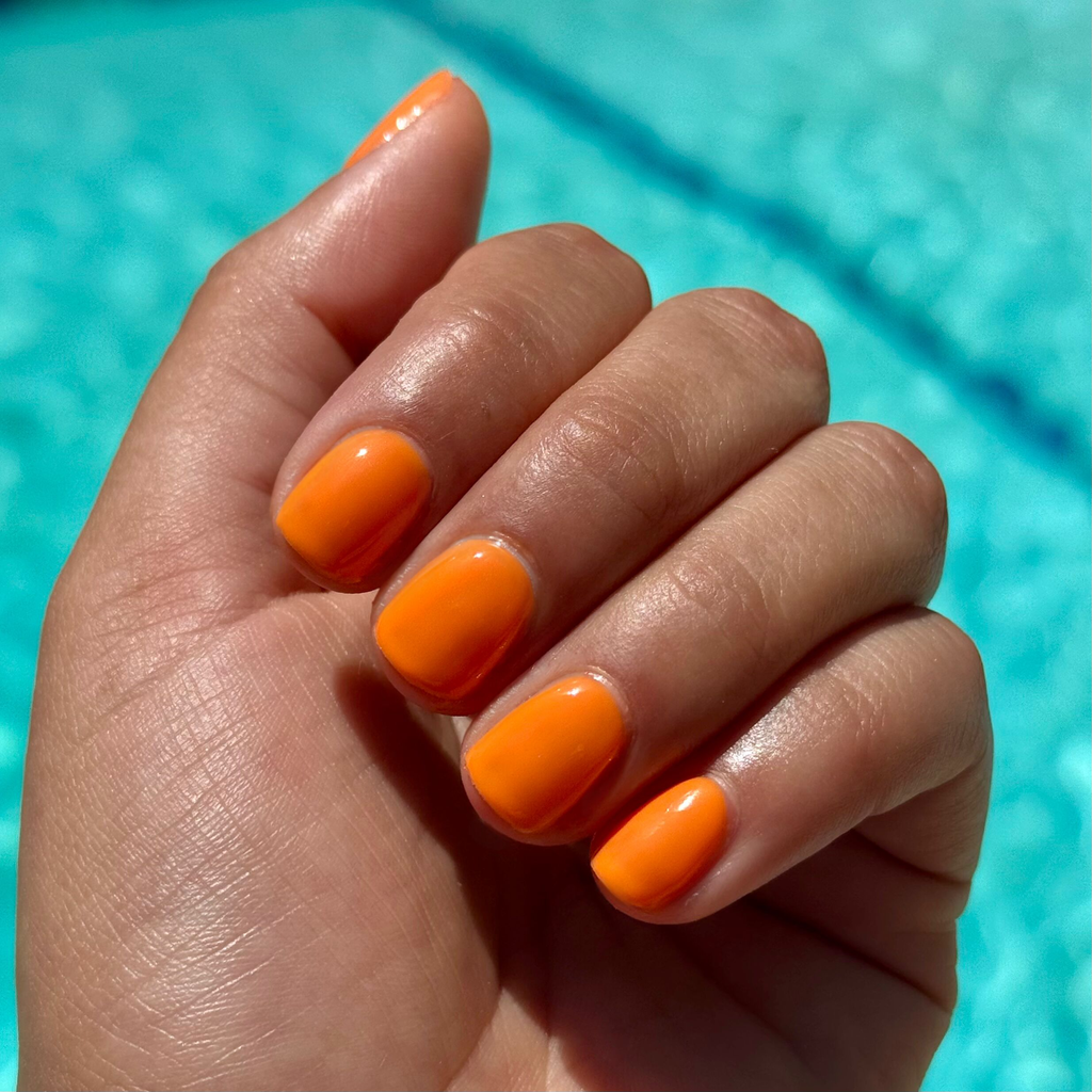 OOO 4EVA - Gel radiant tangerine orange gel polish on short natural nails with shiny smooth finish by poolside