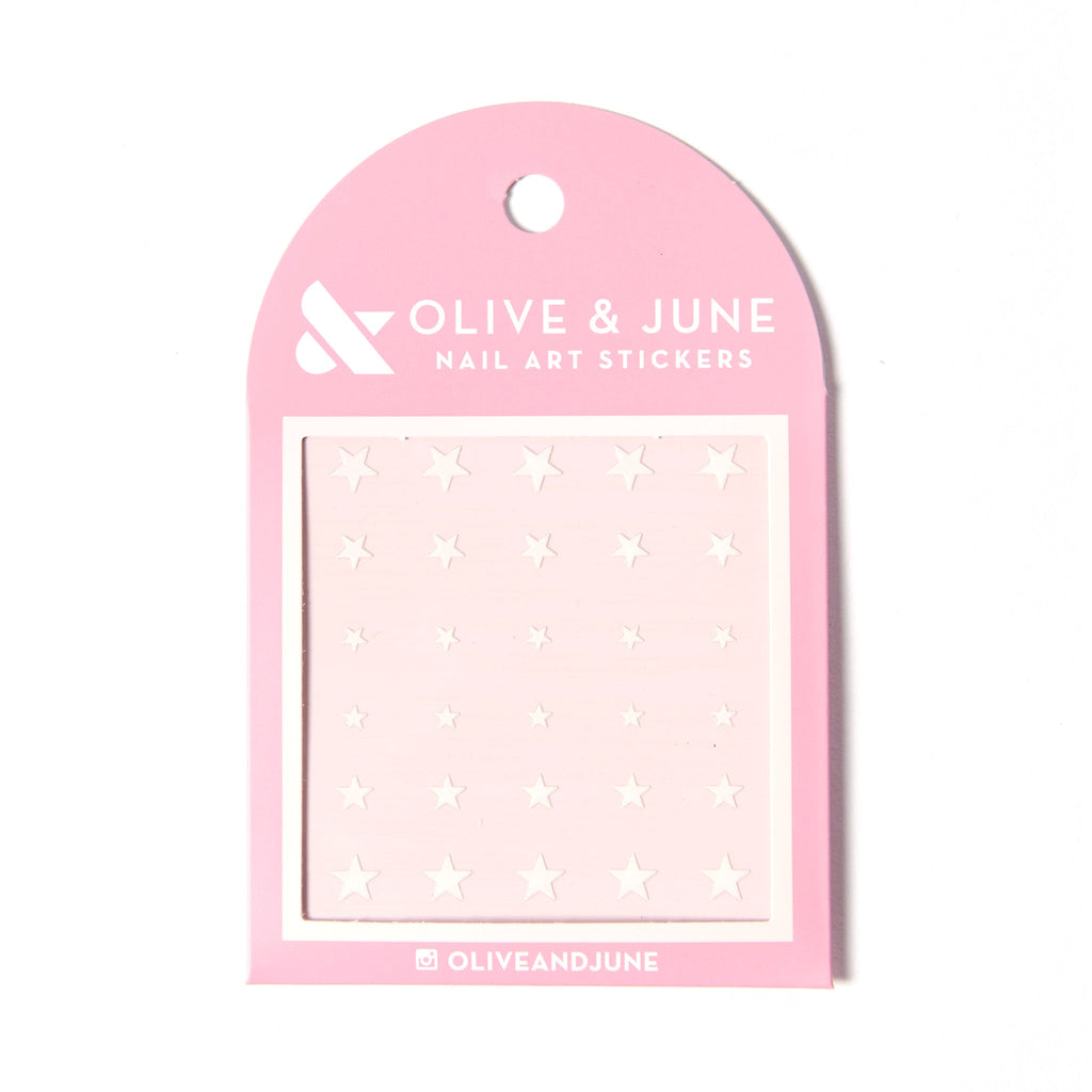White Stars nail art stickers featuring various sizes of white stars on a soft pink backing for mani decoration