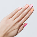 Hand with nails painted in pink and peach shades from the Summer Sorbet Set showing a fresh, long-lasting mani