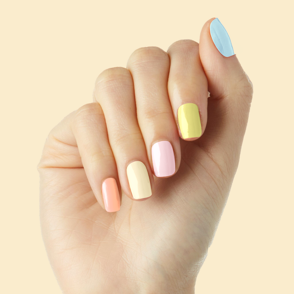 Tutti Frutti set featuring pastel multi-color nails for a bright and cheerful at home manicure and pedicure session