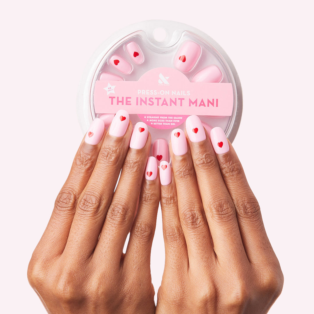 Pink Perfect Heart - Press-On | Round | Short with soft pink and red heart design on natural nails and press-on pack shown above