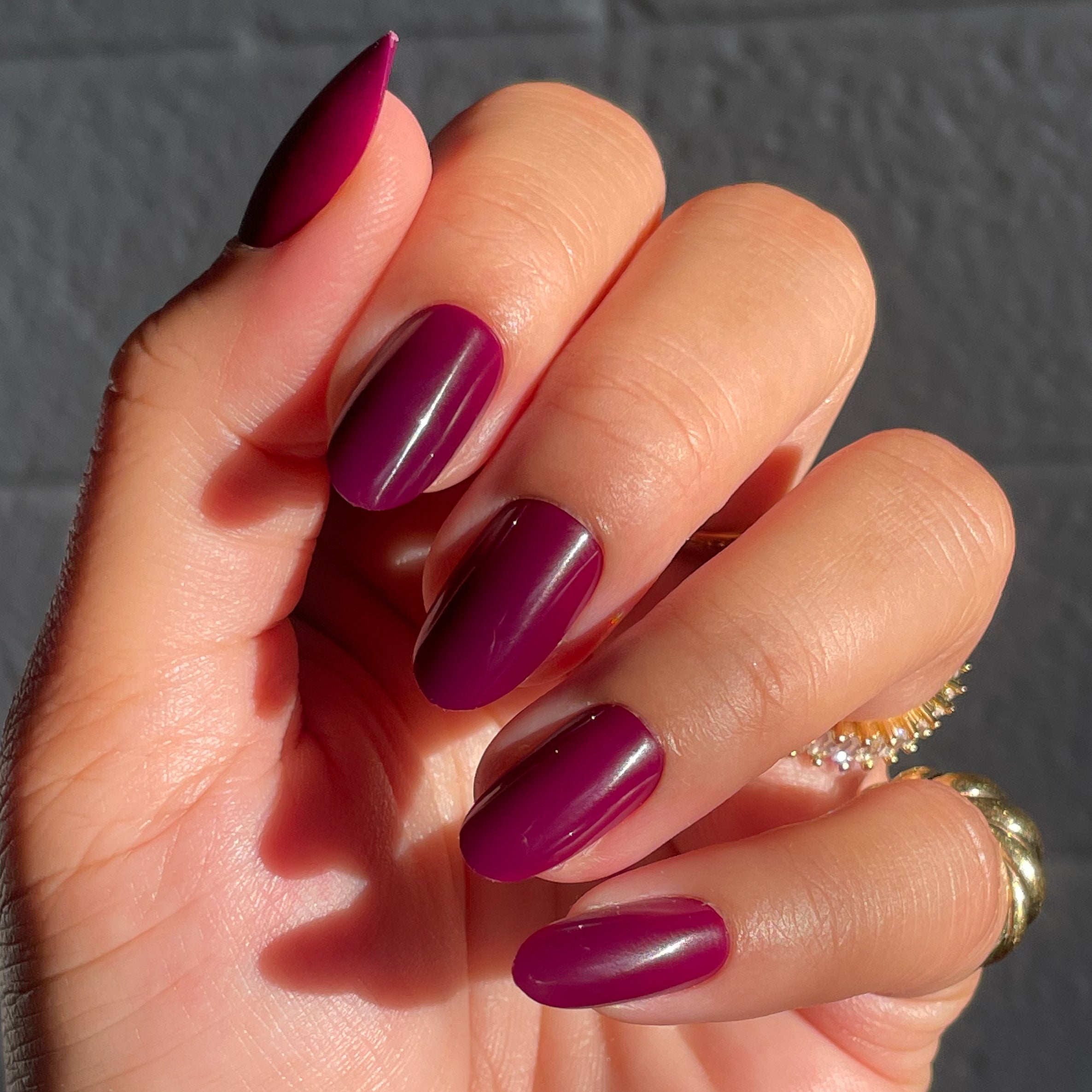 Plaza | Oval | Medium deep mulberry purple press-on nails in a medium oval shape for an easy at-home mani