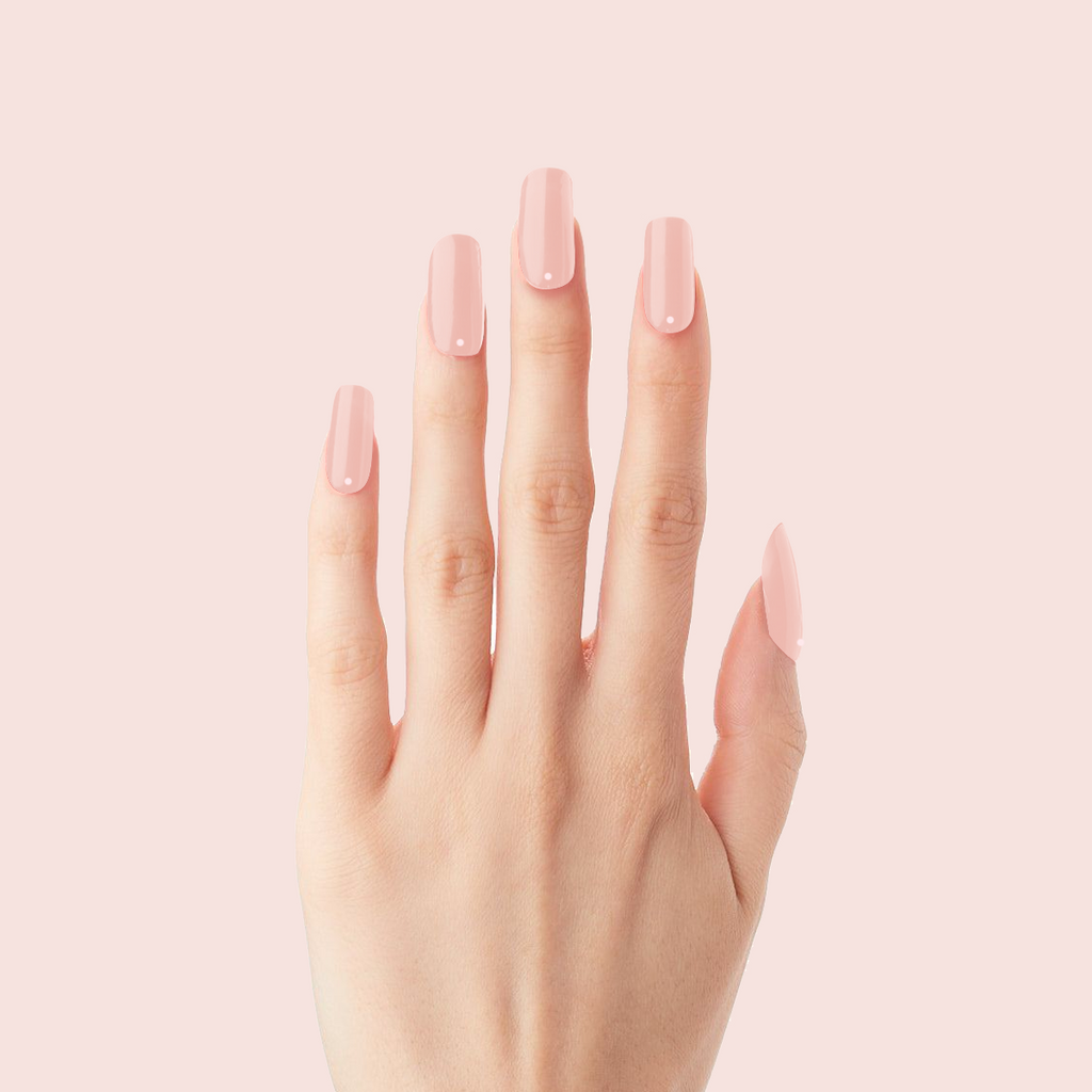 Minimalist Dot - Press-On | Long | Squoval with sheer pink long nails and subtle single dot detail on hand against pale pink background