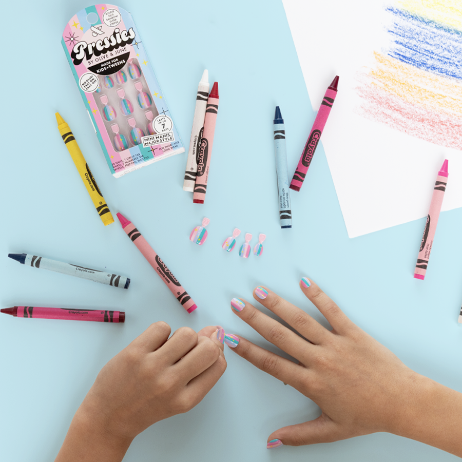 Rainbow Super Stripes - Pressies | Extra Short Short | Round showing kid applying colorful striped press on nails with crayons nearby