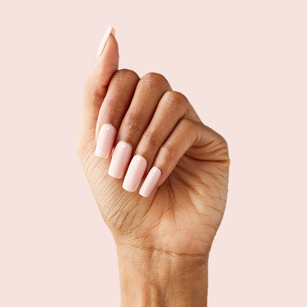Minimalist Dot - Press-On | Long | Squoval long sheer tan nails with single crisp white accent on hand against pale background