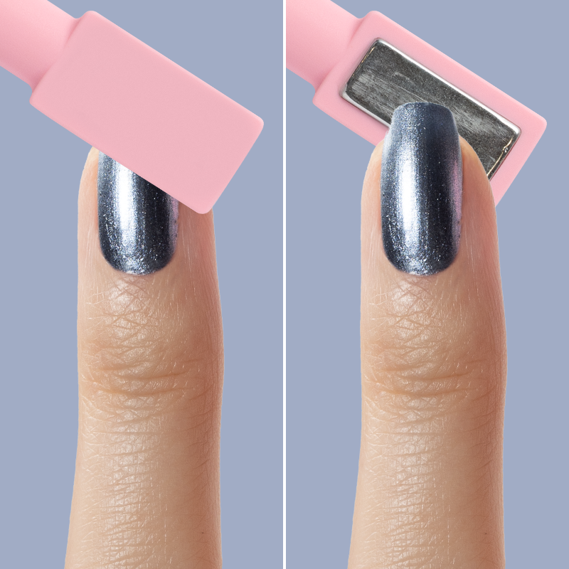 Finger with Sapphire Velvet icy blue magnetic polish showing shimmer effect under pink rectangular magnet tool on blue background