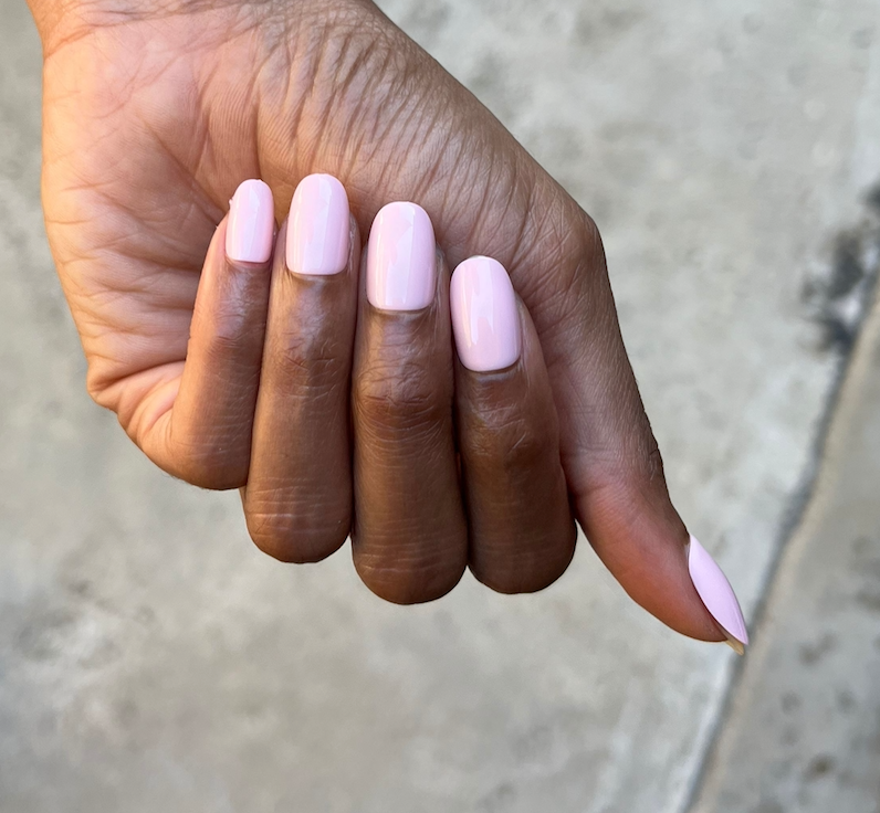 Pink Sands - Press-On | Medium | Oval hand showing medium oval false nails in soft sun-bleached pink manicure shade