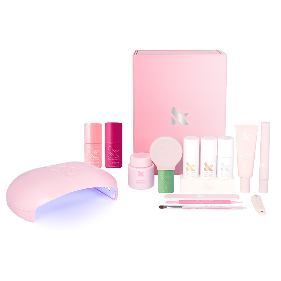Summer Gel Mani System with LED lamp, gel polish bottles, nail care products, and manicure tools in soft pink tones